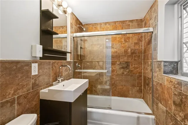 a bathroom with a sink mirror toilet and bathtub