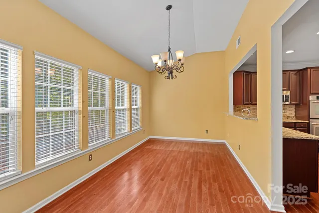 a view of livingroom with hallway and wooden floor