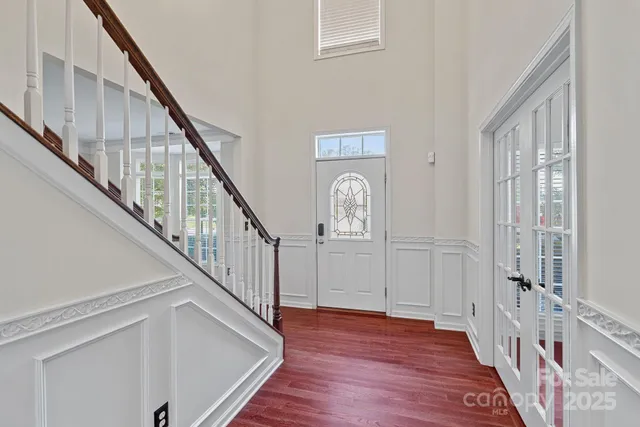 a view of a hallway with wooden floor and entryway