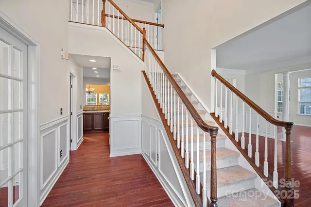 a view of an entryway with wooden floor and stairs
