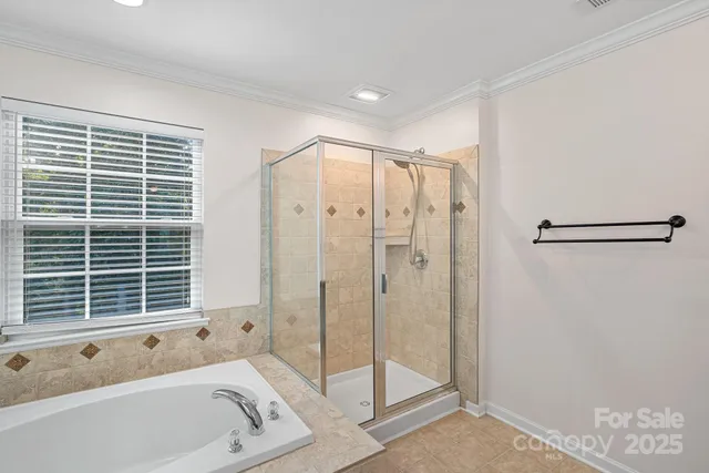 a bathroom with a tub a sink and glass door