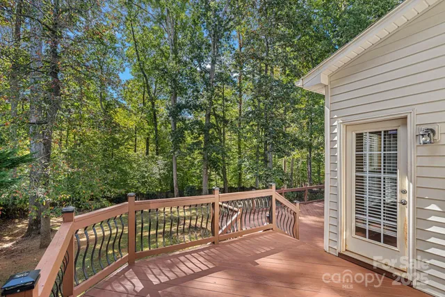 a view of a wooden deck next to a yard