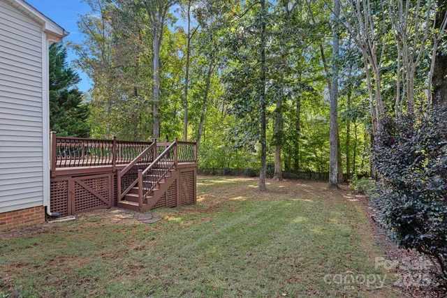 a view of a backyard with wooden fence