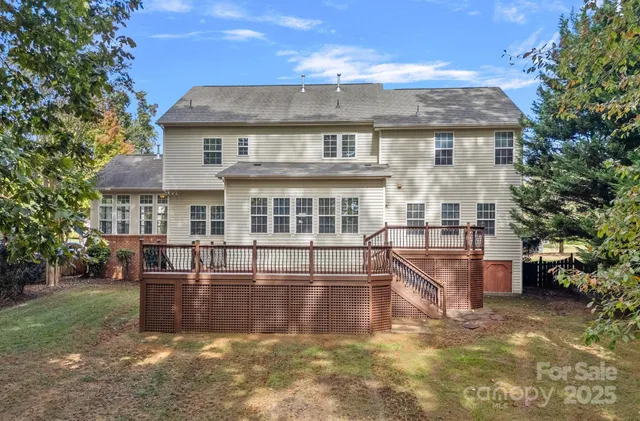 a view of a house with swimming pool and sitting area