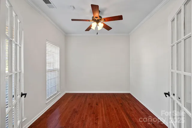 wooden floor in an empty room with a window