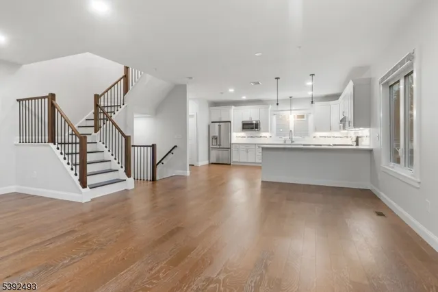 a view of kitchen with wooden floor and electronic appliances