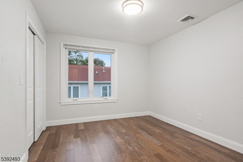 22 Arcadia Place Union, NJ 07088 - Photo 20 of 33 an empty room with wooden floor and windows