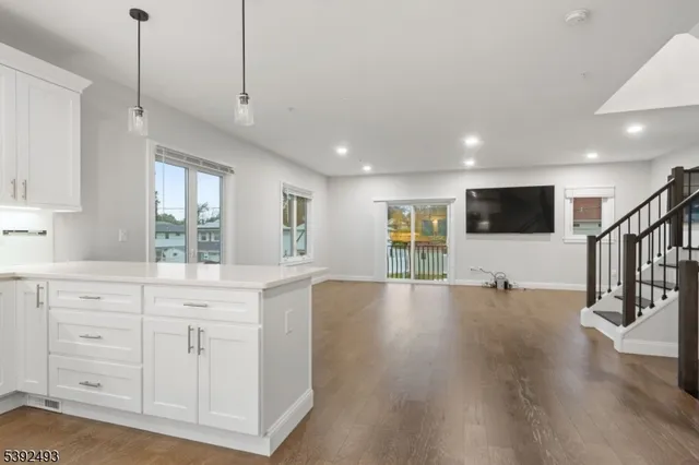 a view of living room with wooden floor and windows