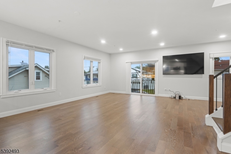 22 Arcadia Place Union, NJ 07088 - Photo 6 of 33 a view of a livingroom with furniture a flat screen tv and wooden floor