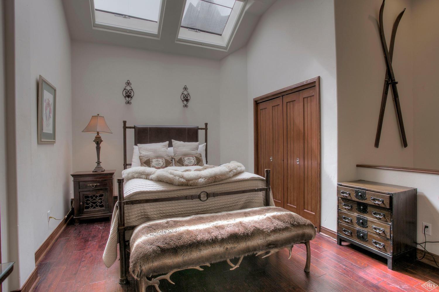 141 Scott Hill Road, Unit 402 Beaver Creek, CO 81620 - Photo 13 of 23 a bedroom with a bed and a tv