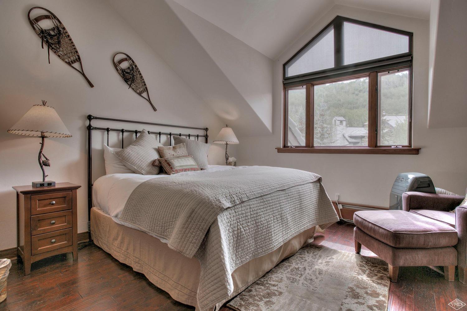 141 Scott Hill Road, Unit 402 Beaver Creek, CO 81620 - Photo 15 of 23 a bedroom with a bed a dresser and next to a window