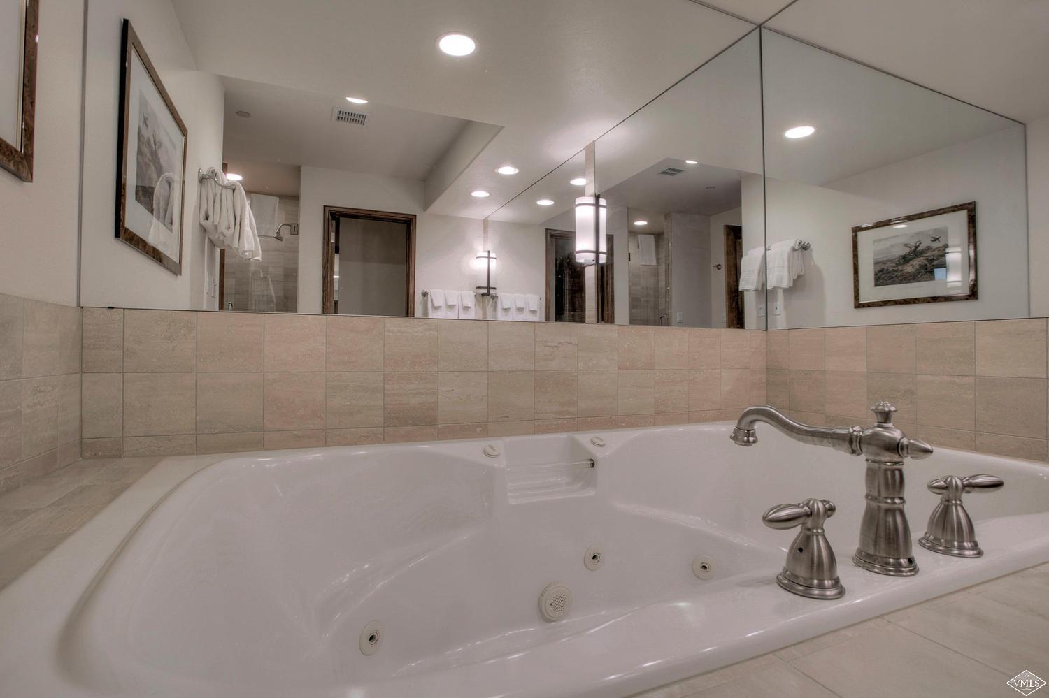 141 Scott Hill Road, Unit 402 Beaver Creek, CO 81620 - Photo 19 of 23 a bathroom with a bathtub and shower