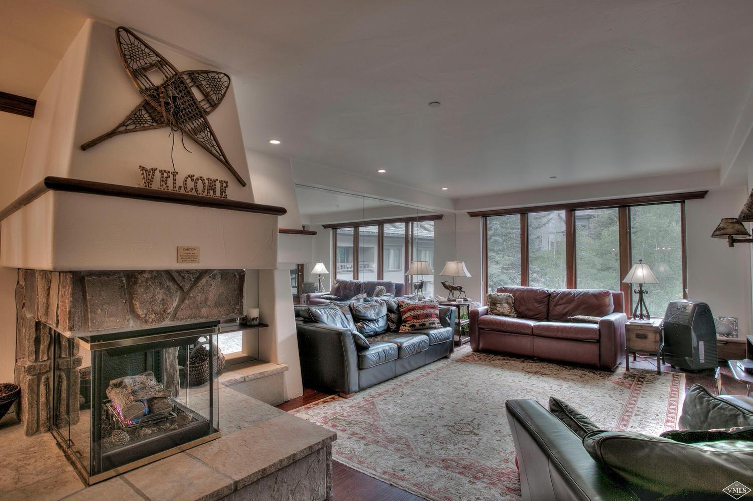 141 Scott Hill Road, Unit 402 Beaver Creek, CO 81620 - Photo 2 of 23 a living room with furniture and a fireplace