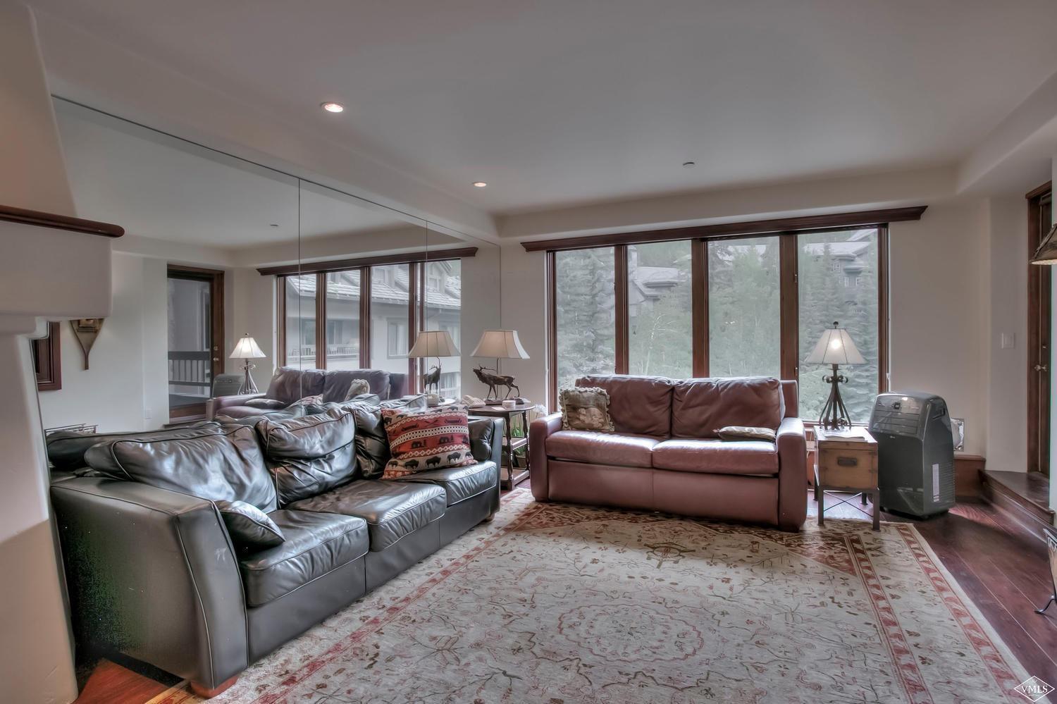 141 Scott Hill Road, Unit 402 Beaver Creek, CO 81620 - Photo 3 of 23 a living room with furniture and a large window