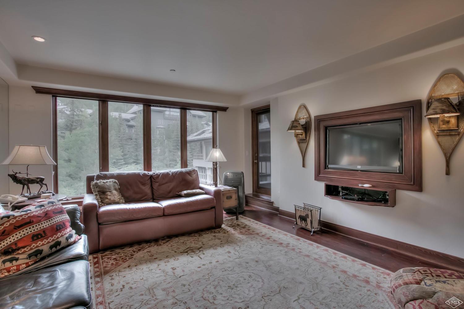 141 Scott Hill Road, Unit 402 Beaver Creek, CO 81620 - Photo 4 of 23 a living room with furniture and a flat screen tv