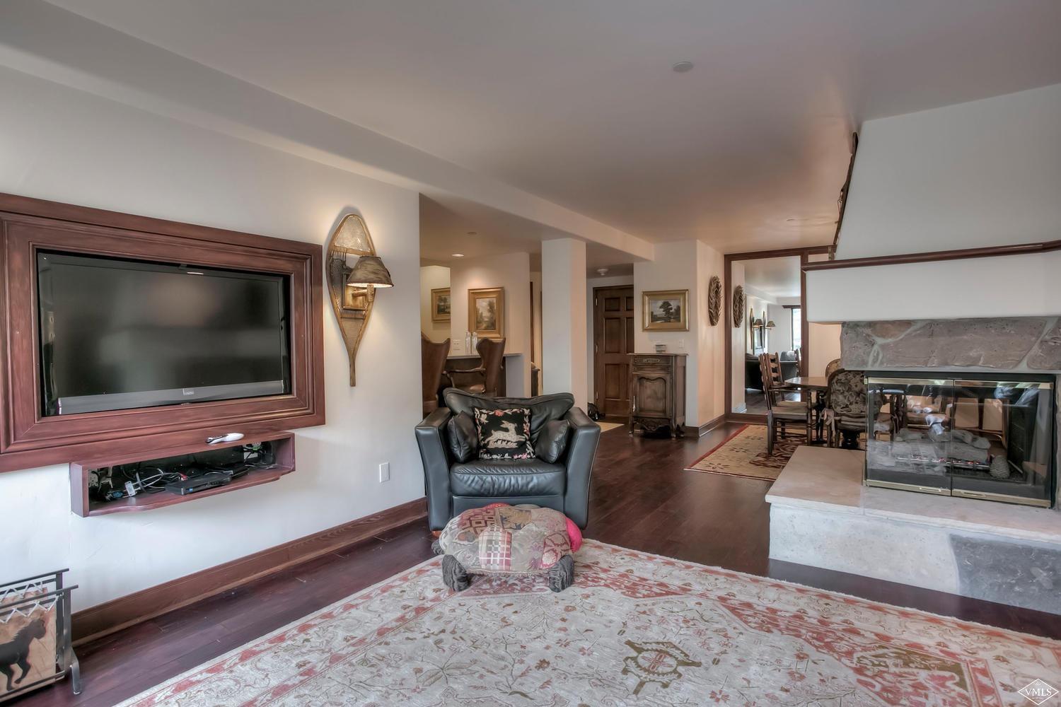 141 Scott Hill Road, Unit 402 Beaver Creek, CO 81620 - Photo 5 of 23 a living room with furniture and a flat screen tv