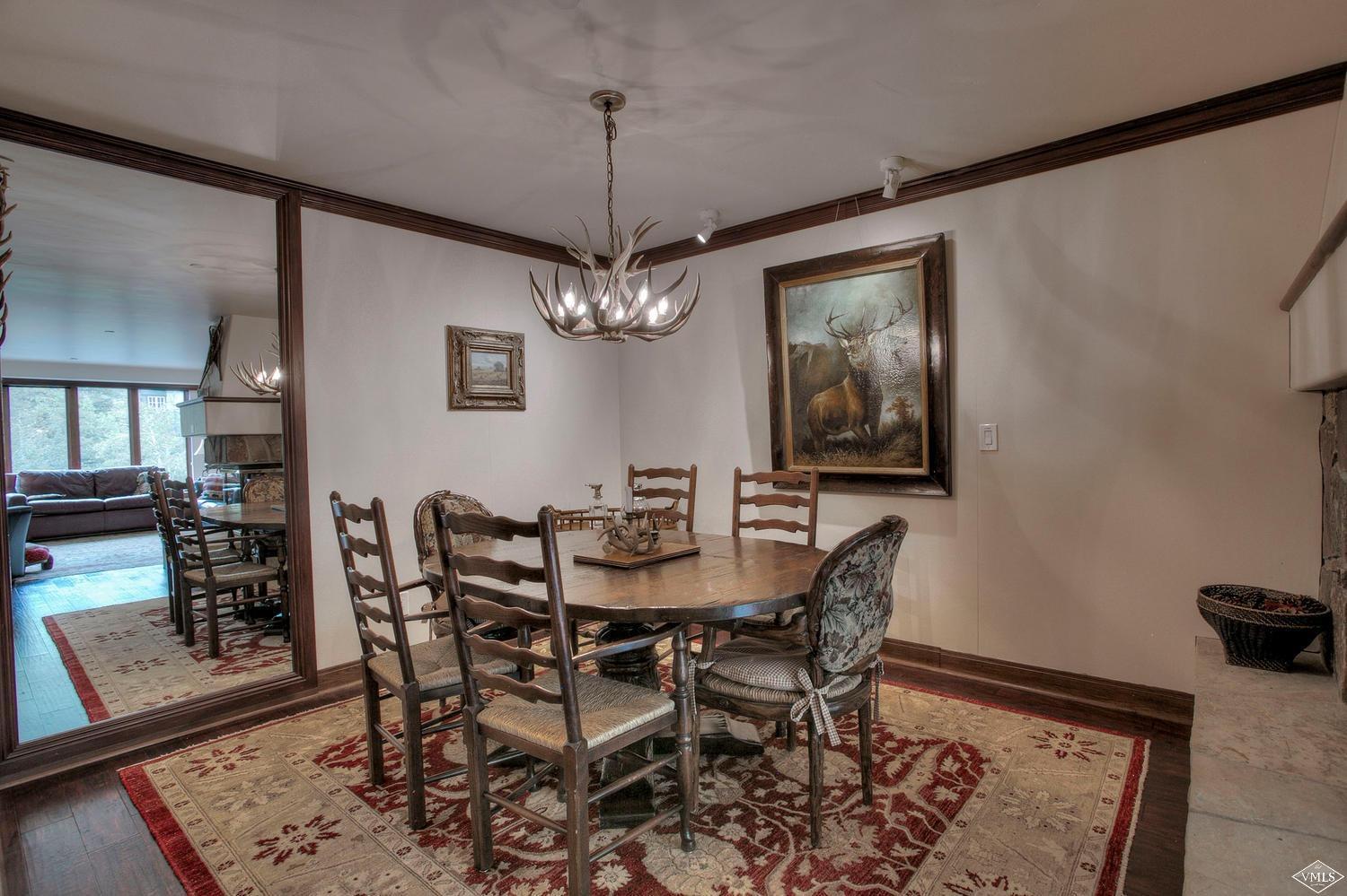 141 Scott Hill Road, Unit 402 Beaver Creek, CO 81620 - Photo 6 of 23 a view of a dining room with furniture and chandelier