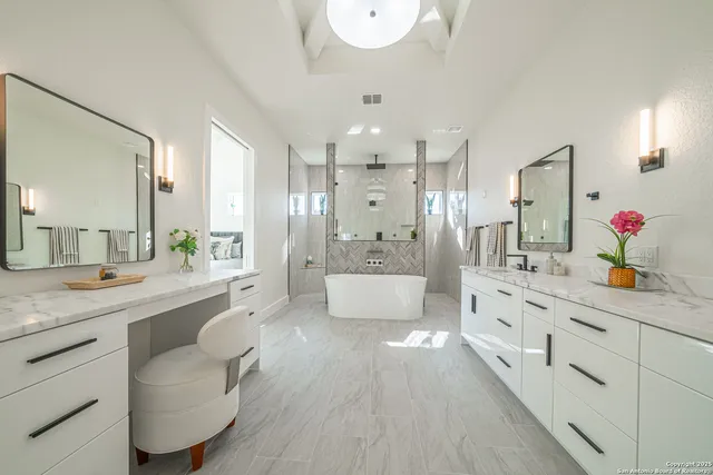 a large bathroom with a granite countertop sink a toilet a mirror and vanity