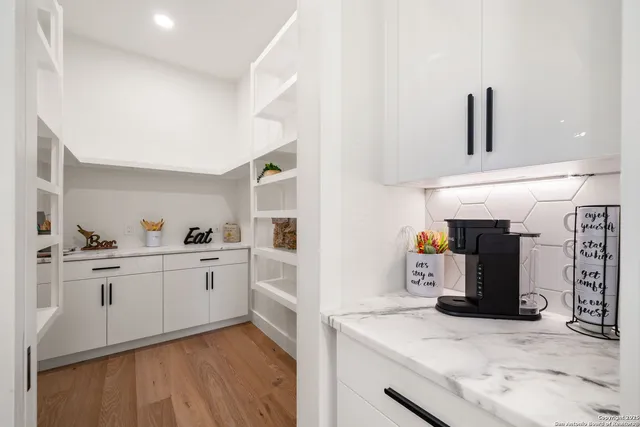 a kitchen with stainless steel appliances kitchen island granite countertop a refrigerator and stove