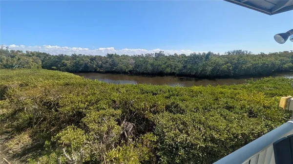 a very nice looking room with many windows and furniture