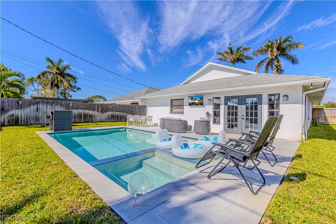 754 105th Avenue North Naples, FL 34108 - Photo 2 of 32 a view of a swimming pool with chairs