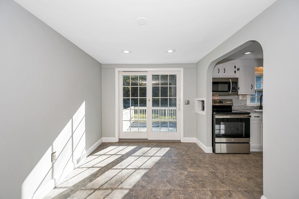 26 Ledge Road Chelmsford, MA 01863 - Photo 8 of 33 a view of a kitchen with an empty space and a fireplace