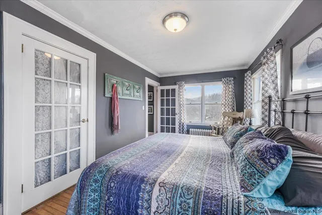 a spacious bedroom with a large bed and a large window