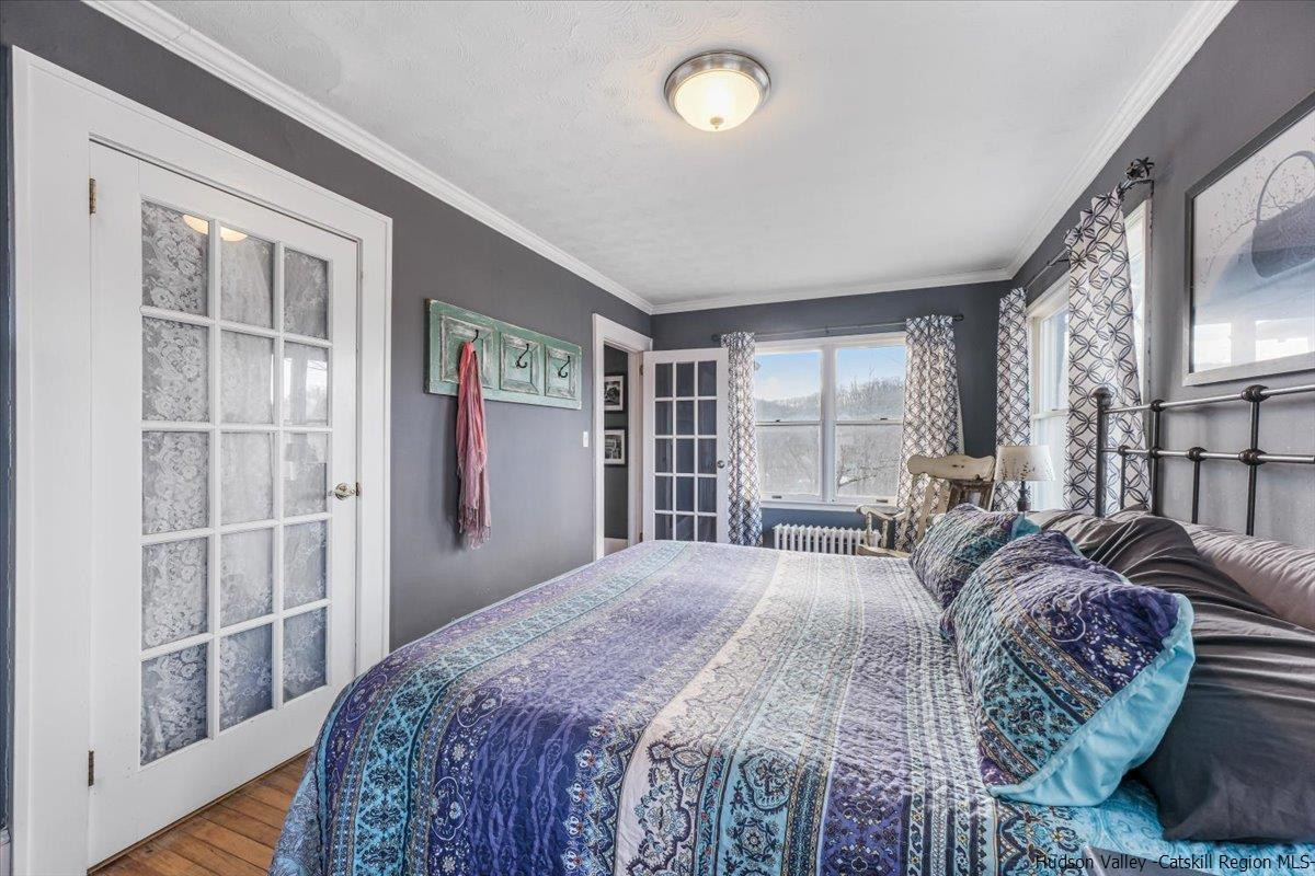 98 North Road Highland, NY 12528 - Photo 12 of 33 a spacious bedroom with a large bed and a large window
