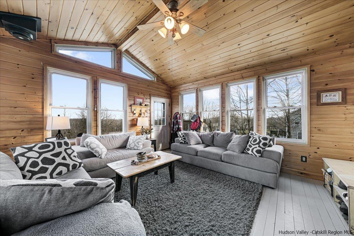 98 North Road Highland, NY 12528 - Photo 14 of 33 a living room with furniture ceiling fan and a large window
