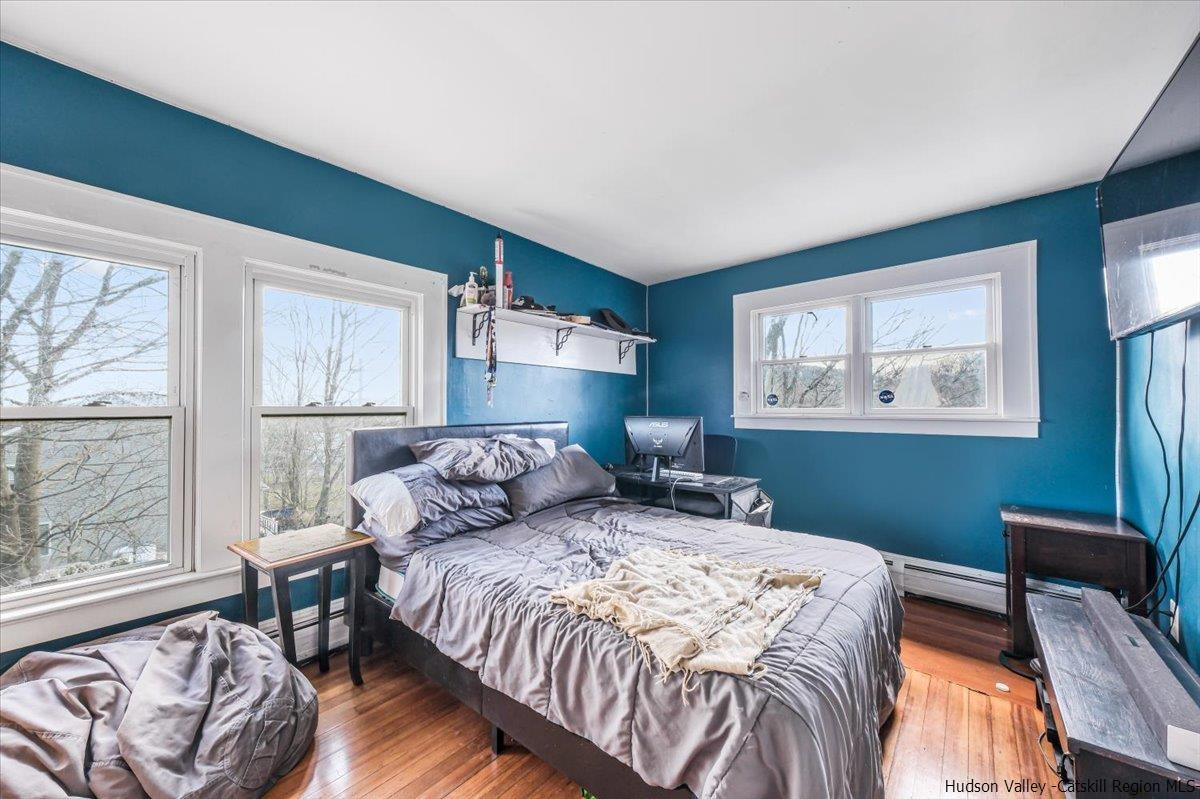 98 North Road Highland, NY 12528 - Photo 19 of 33 a bedroom with a bed and wooden floor