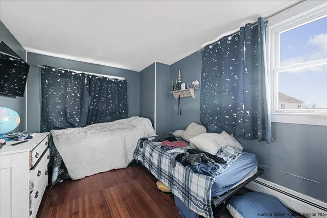 a bed sitting in a bedroom next to a window