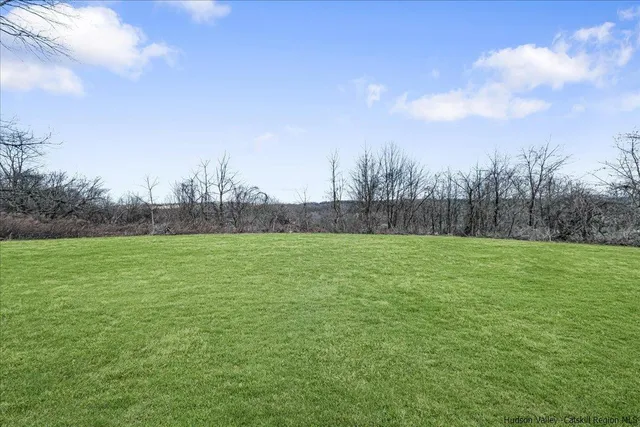 a view of field and trees in the background