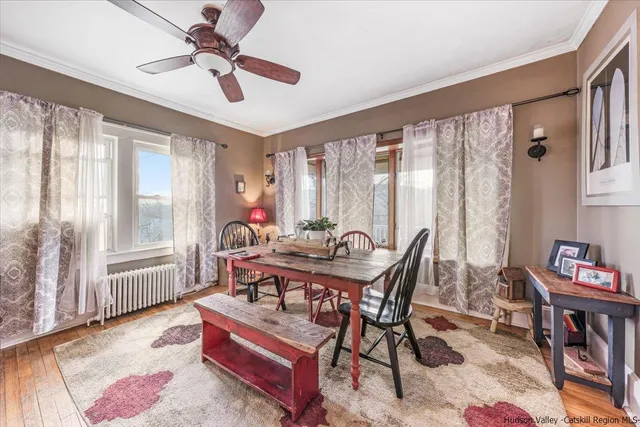 a dining room with furniture a rug and a large window