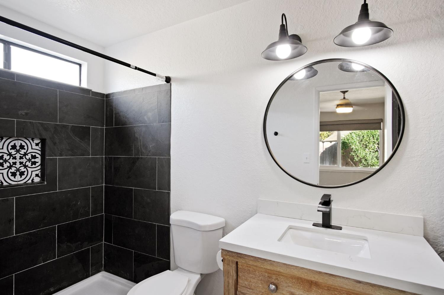 3161 Bridgeport Court Turlock, CA 95382 - Photo 13 of 31 a bathroom with a sink mirror and toilet