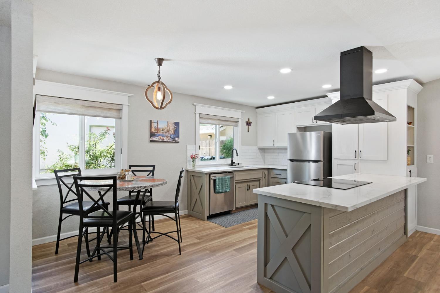 3161 Bridgeport Court Turlock, CA 95382 - Photo 16 of 31 a dining room with furniture a chandelier and wooden floor
