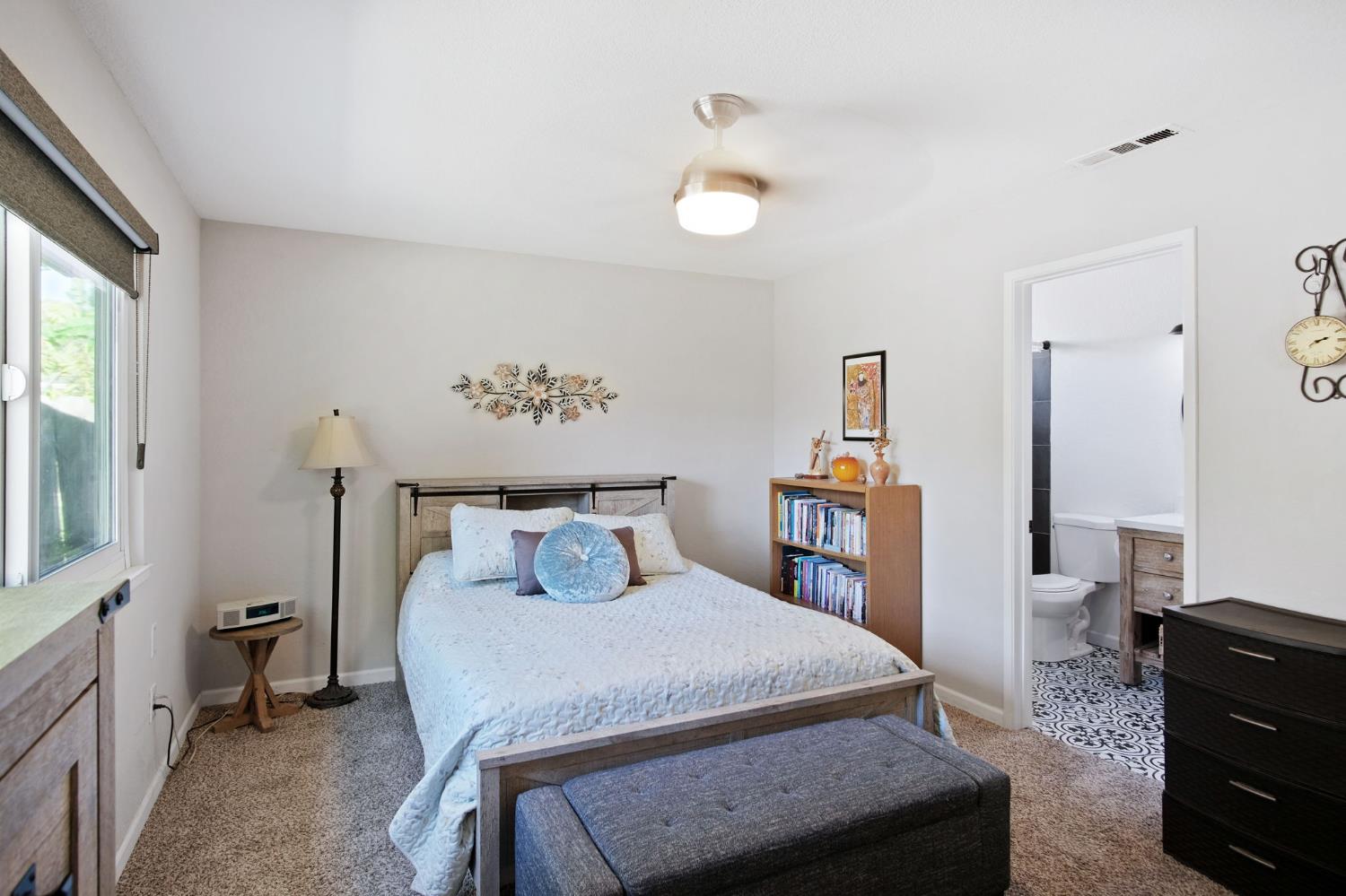 3161 Bridgeport Court Turlock, CA 95382 - Photo 17 of 31 a bedroom with a bed and a chandelier