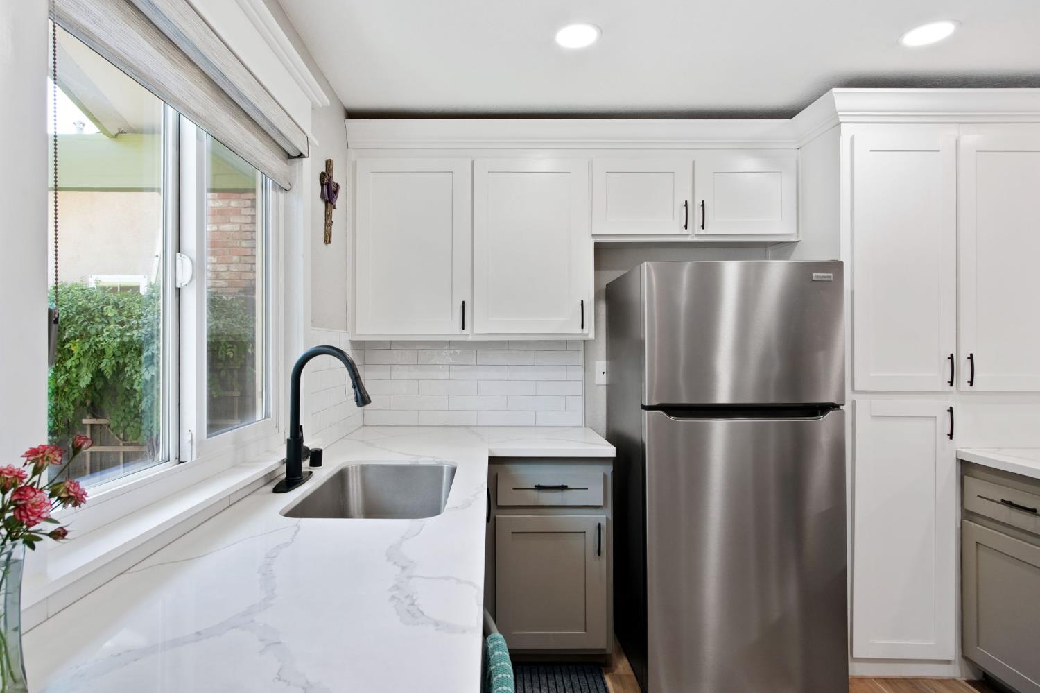 3161 Bridgeport Court Turlock, CA 95382 - Photo 18 of 31 a kitchen with refrigerator a sink and white cabinets