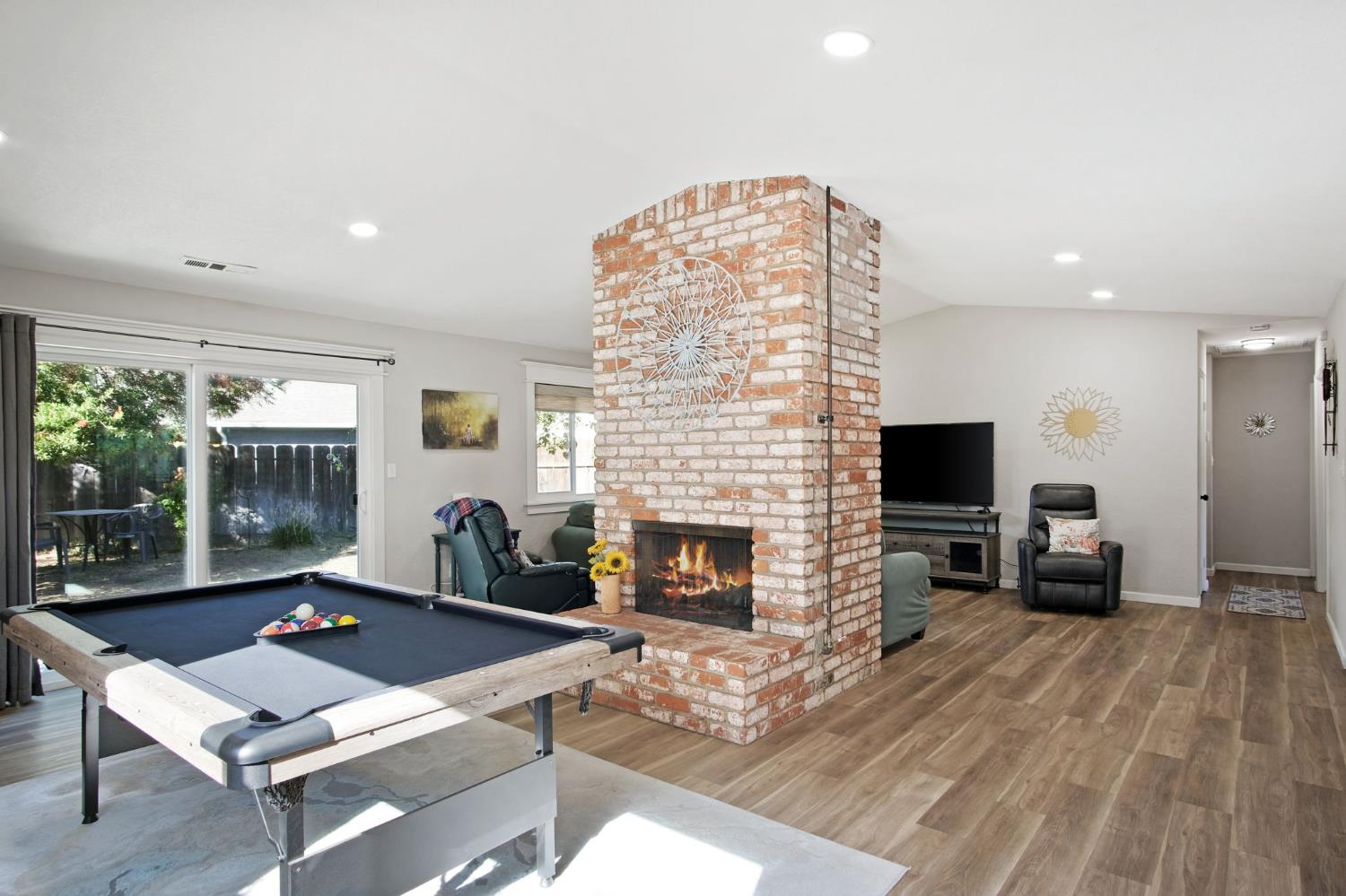 3161 Bridgeport Court Turlock, CA 95382 - Photo 24 of 31 a living room with furniture a fireplace and a flat screen tv