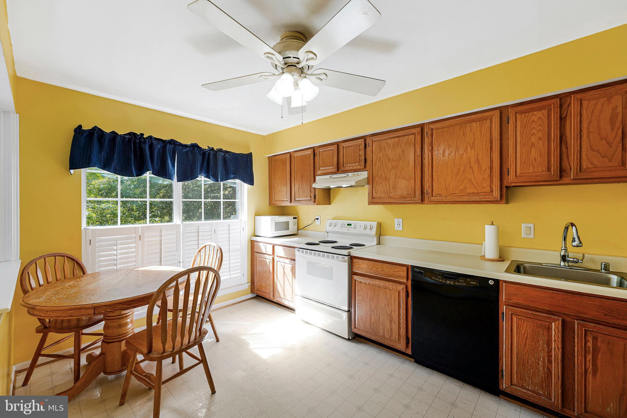 5803 Walden Commons Court Burke, VA 22015 - Photo 2 of 20 a kitchen with a stove a sink and cabinets