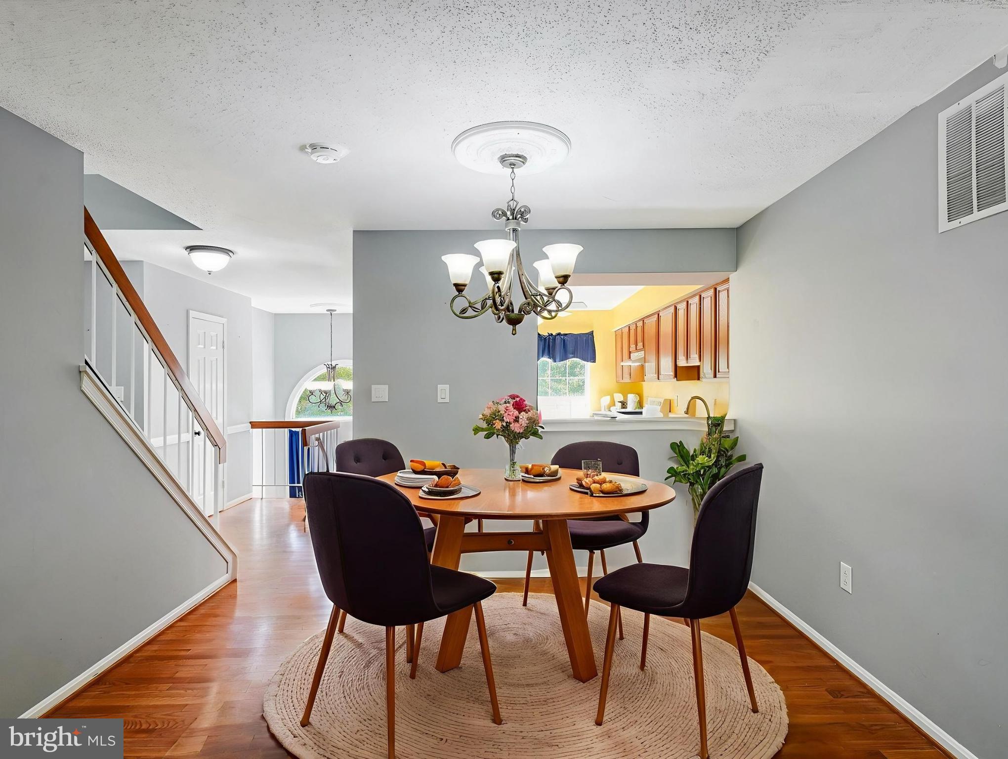 5803 Walden Commons Court Burke, VA 22015 - Photo 4 of 20 a view of a dining room with furniture and wooden floor
