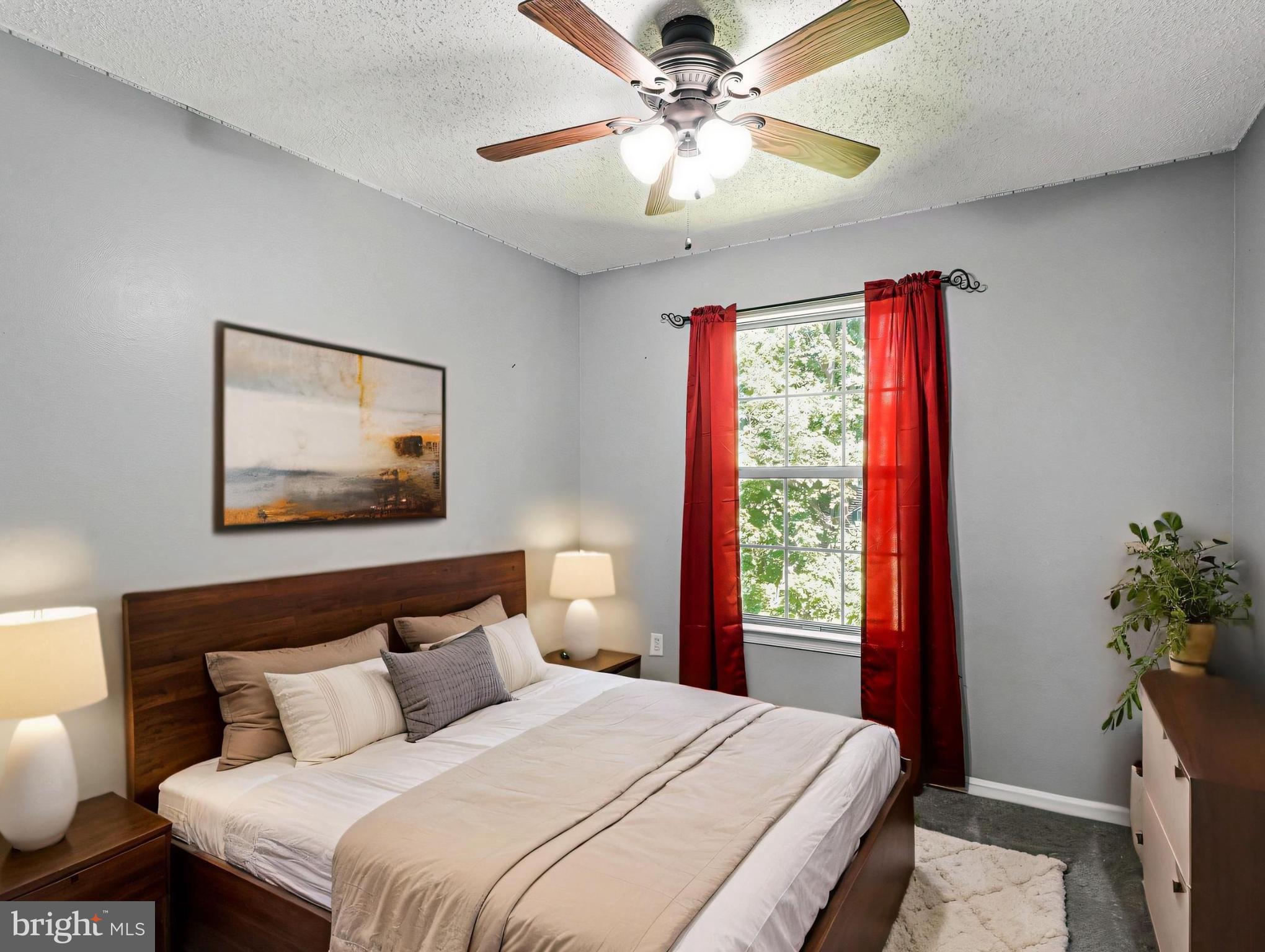 5803 Walden Commons Court Burke, VA 22015 - Photo 10 of 20 a bedroom with a bed and a chandelier
