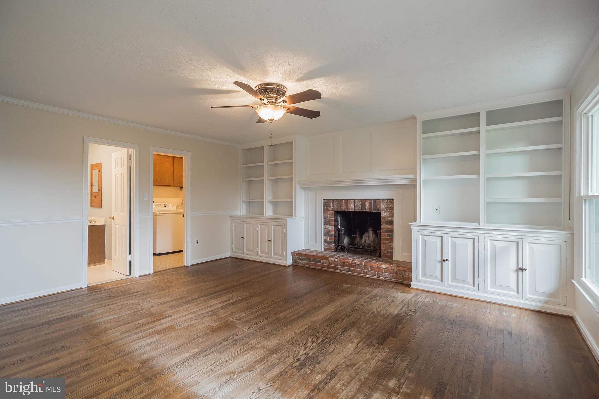 9448 Lovat Road Fulton, MD 20759 - Photo 13 of 30 a view of an empty room with a fireplace and a window