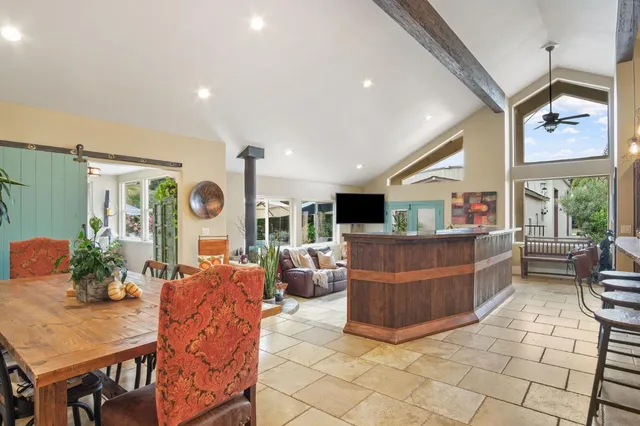 a living room with furniture and a floor to ceiling window