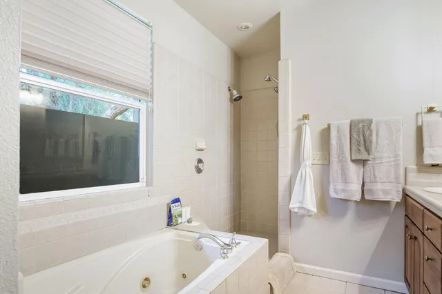 a living room with furniture a chandelier and a window