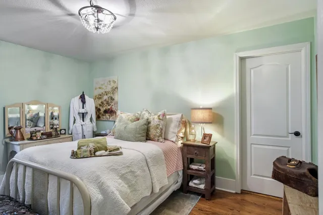 a view of a swimming pool with a table and chairs under an umbrella