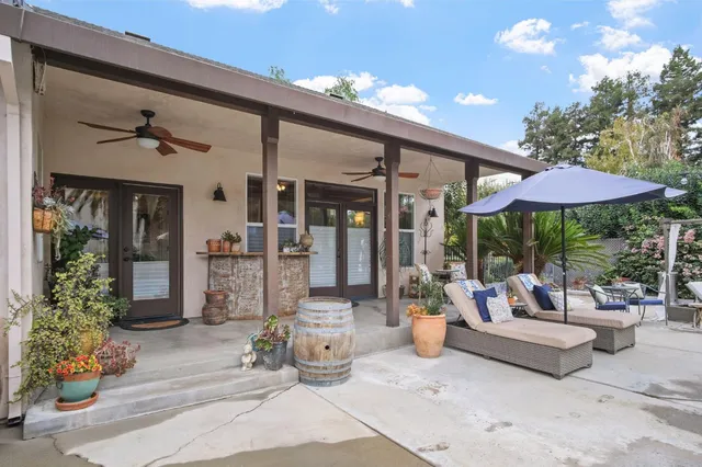 a view of a backyard with sitting area and furniture
