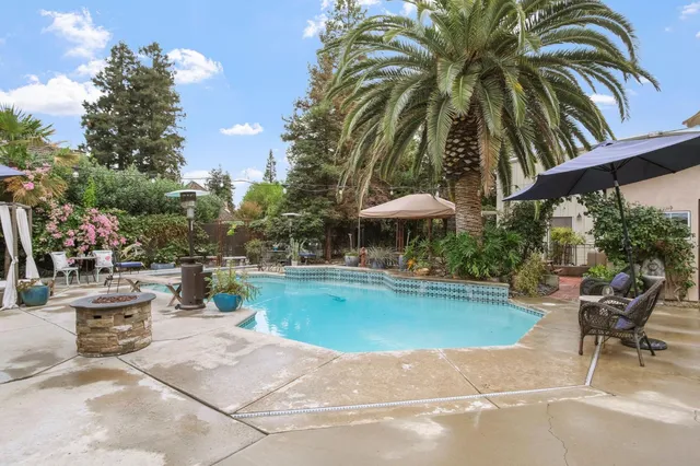 a kitchen with stainless steel appliances white cabinets and a fireplace