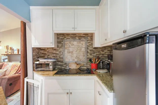 a view of a house with a yard and potted plants