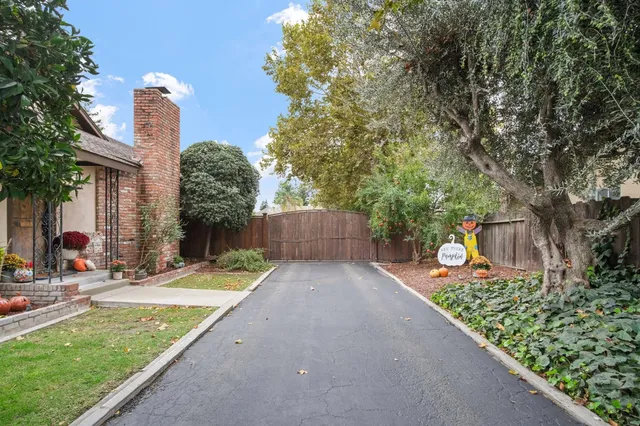 a front view of a house with garden and plants