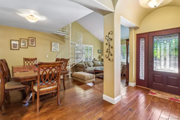 a kitchen with kitchen island granite countertop a table and chairs in it